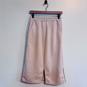 Sporty pale pink knee length skirt with front slit, draw string at waistband m
